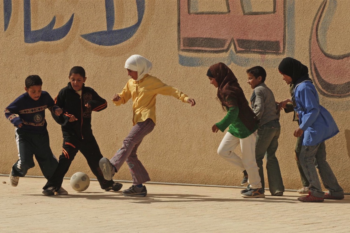 Girls and boys play football at a boarding school for nomadic Bedouin children in Syria. (2006)