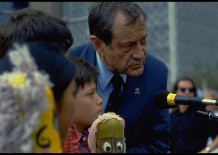 UNICEF Executive Director James Grant, together with children representing several countries, addresses the Outdoor Forum, held on the North Lawn at United Nations Headquarters on September 26, 1990 in celebration of the World Summit for Children.