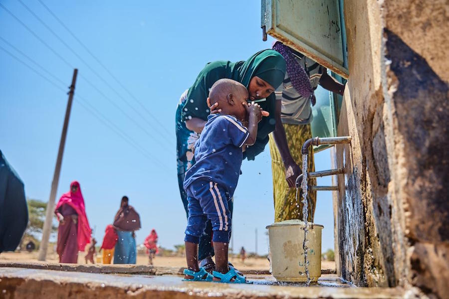 In Daley Village, Garissa County, Kenya, Nasri Garane washes her 2-year-old son’s face at the UNICEF-supported water kiosk where she goes to collect safe water for her household. 