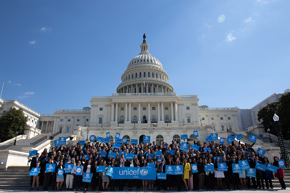 Volunteers holding UNICEF USA signs in front of the US Capitol.