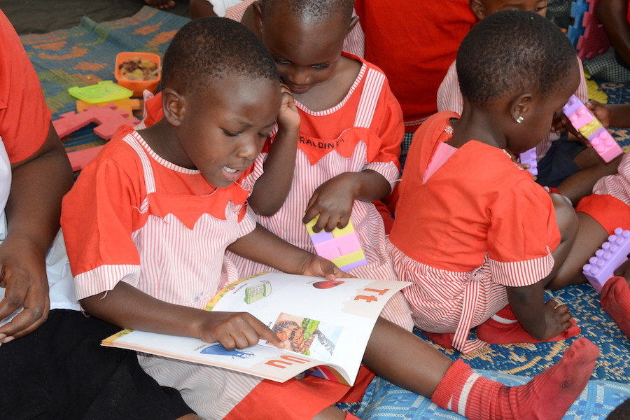 Children read and write in a tent set up during a UNICEF Early Childhood Development activation in the stadium of Kabale Municipality in South Western Uganda on February 2, 2017. 