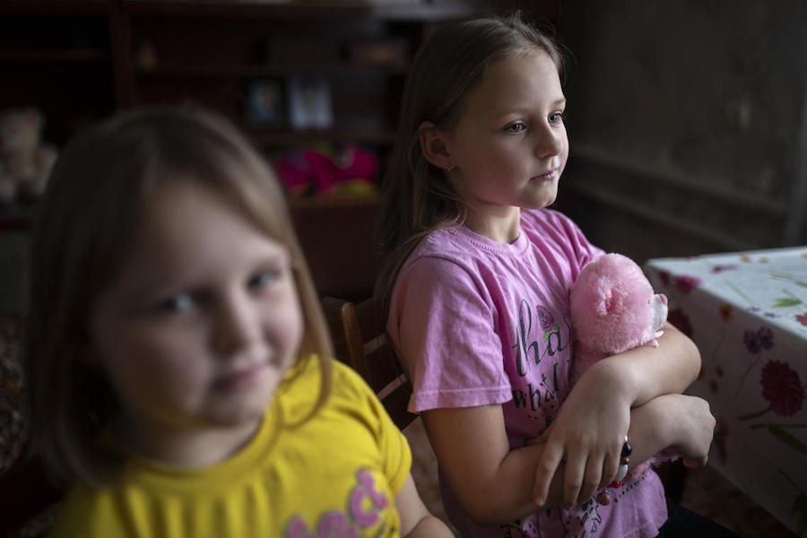 From left: Sisters Katya, 7, and Daryna, 9, in their home in eastern Ukraine.
