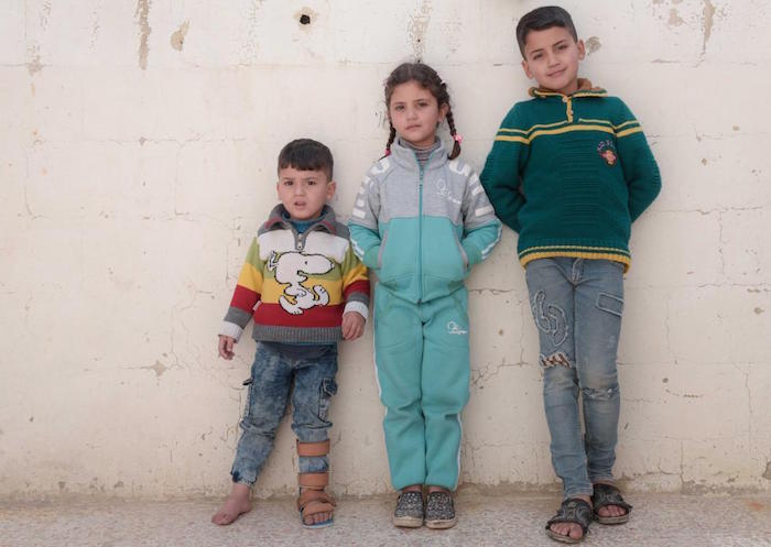 Siblings Anwar, 9, Nada, 6, and Mohammad, 3, are growing up in war-torn Syria. A UNICEF-supported cash transfer program helps their family pay for winter clothes and other necessities. 