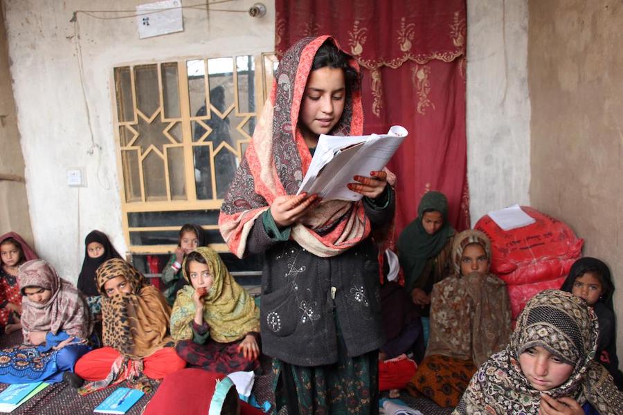 Wasilla, 12, (center) is enrolled in a UNICEF-supported accelerated learning center in Kotal Morcha village, Kandahar province, Afghanistan. 