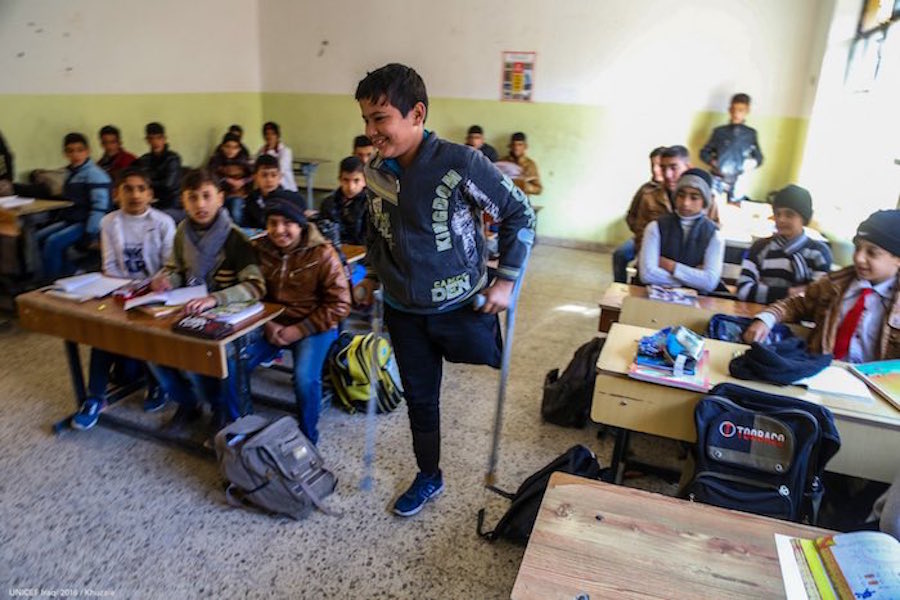 Hamed, 13, walks up to the blackboard at a school in Fallujah. © UNICEF Iraq/2016/Khuzaie