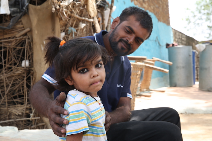 A father with his daughter in Uttar Pradesh, India, where UNICEF and partners rolled out a service that guides parents in how to support their child's development at home.