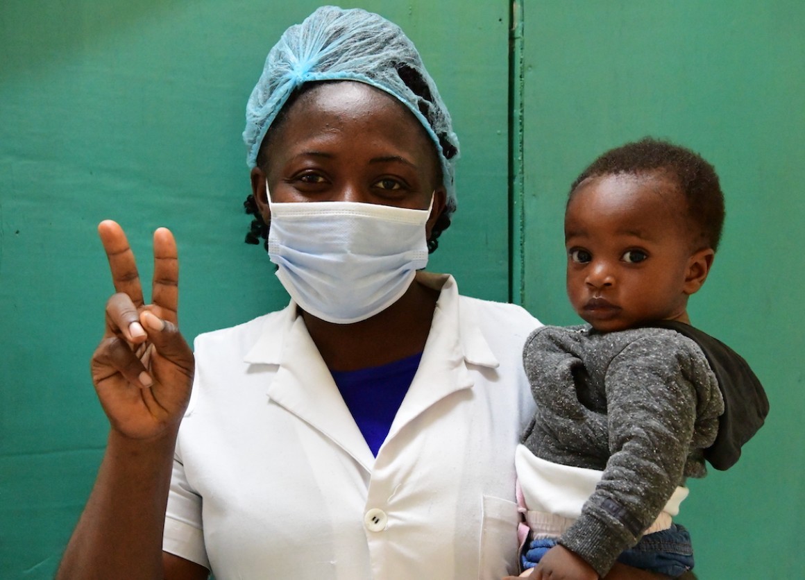 A nurse at Buéa Regional Hospital in Buéa, Southwest Cameroon, flashes a "V for vaccinated" sign showing that she has received a coronavirus vaccine. 