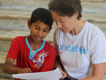 A young boy speaks with UNICEF Media Specialist Rebecca Fordham, at a UNICEF-supported workshop in the eastern city of Benghazi.