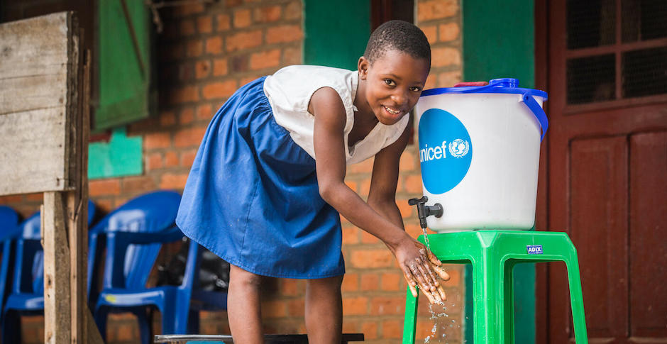 A student washes her hands outside Elikya Primary School in Mbandaka, DRC.