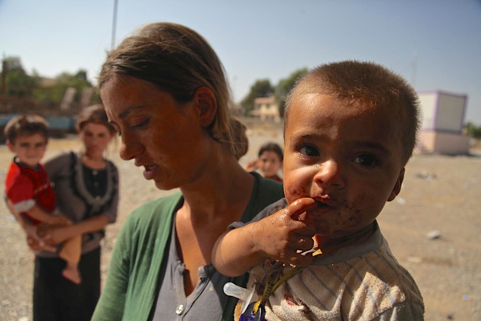 In August 2014, a woman and her young son are among displaced Yazidi children and adults sheltering in Dohuk Governorate, Iraq. UNICEF is providing services for displaced Yazidi  families.
