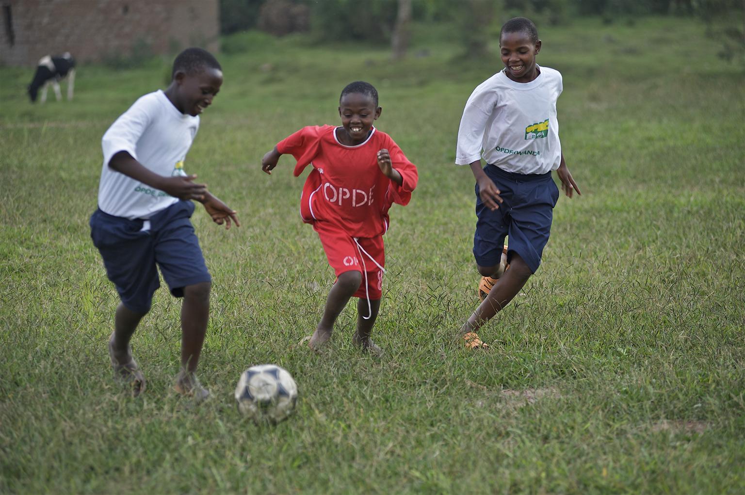 Eric (10, middle) plays football/soccer with other children at a UNICEF-supported hostel for street children in Taba, Malawi.