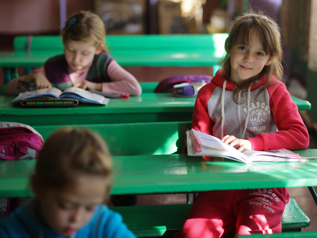 A girl reads during a class in School No. 6 in Yasinovataya, Donetsk region, Ukraine, 24 October 2016.