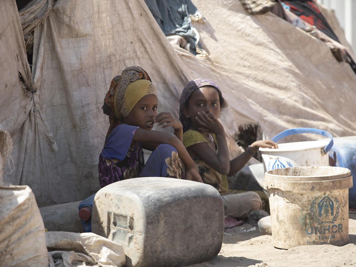 Children sit outside their tent at Al-Meshqafah camp for displaced persons in Lahj governate, southern Yemen, in February 2019.