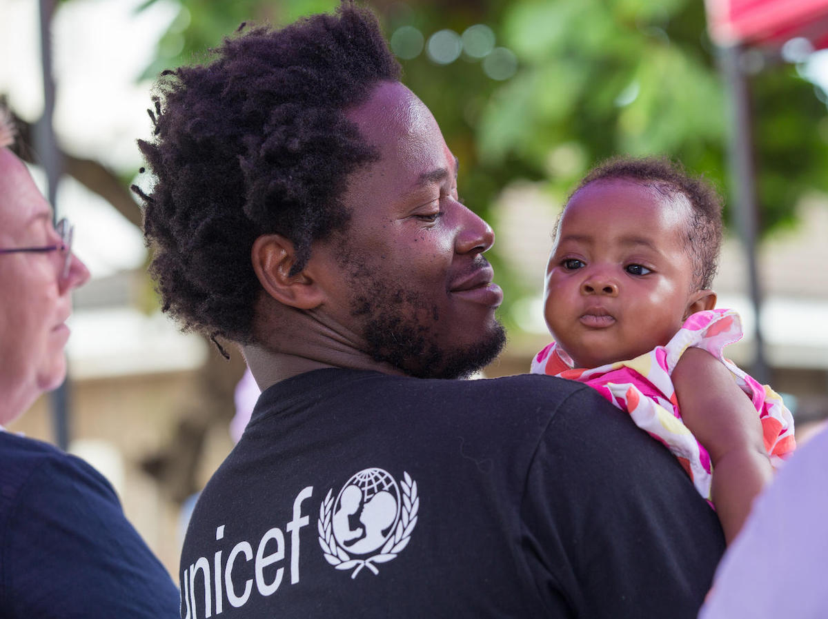 Ishmael Beah, author, former child soldier and UNICEF Advocate for Children Affected by War, holds a baby girl during a visit to Ola During Children's Hospital in Freetown, Sierra Leone, on 17 November 2019. 