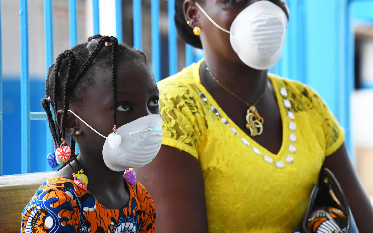 A mother and daughter wear masks during a visit to the UNICEF-supported health center outside Abidjan, in the south of Côte d'Ivoire, to protect them from COVID-19.