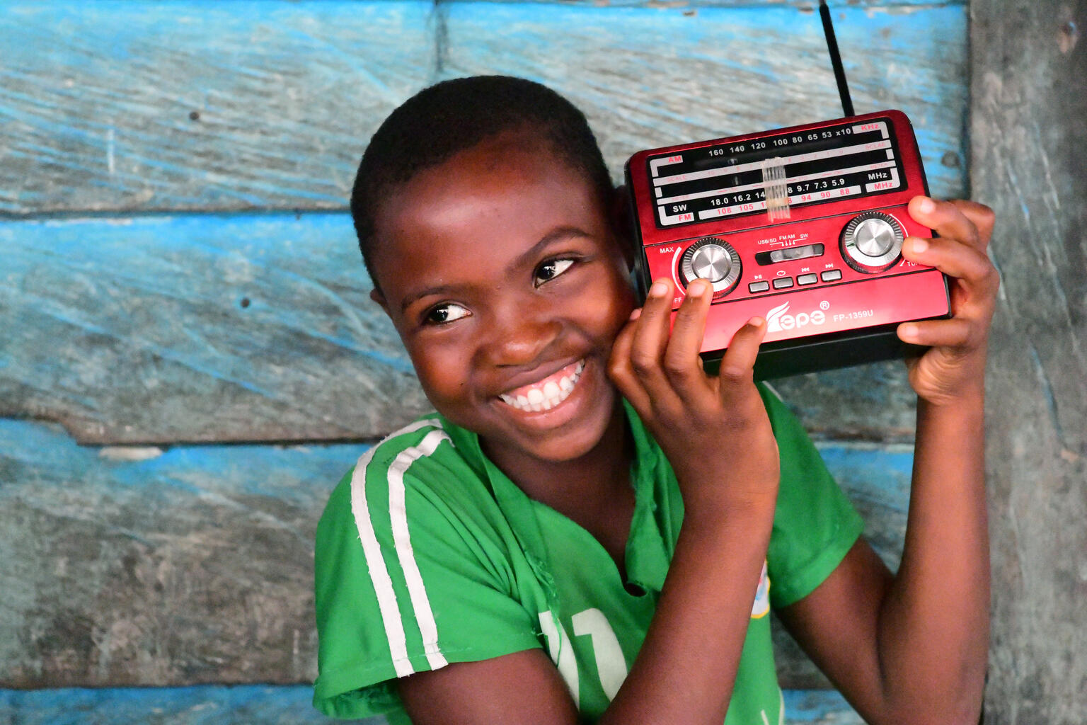 Keren, a 12 years old girl, is listening to a radio education program, in the community of Idinau, in the south west of Cameroon