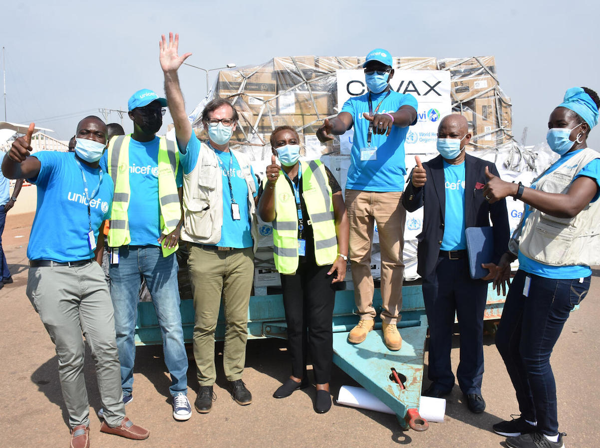 UNICEF staff cheering at Juba International Airport after the arrival of the first batch of COVID-19 vaccines in South Sudan via the COVAX Facility. 