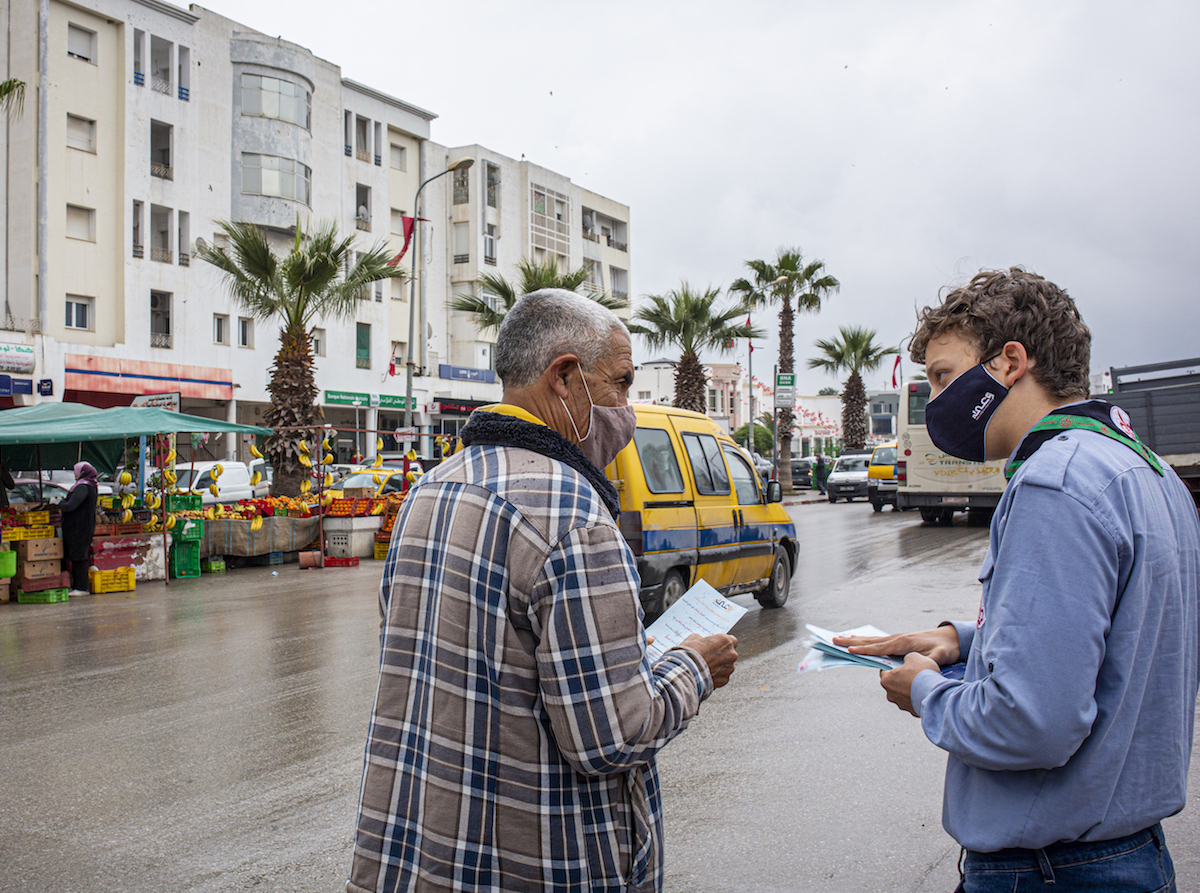 In Mhamdia, in the suburbs of Tunis, Tunisia, a group of UNICEF-trained Scouts talk to pedestrians about the risks of COVID-19 and share information about how to prevent infection. 