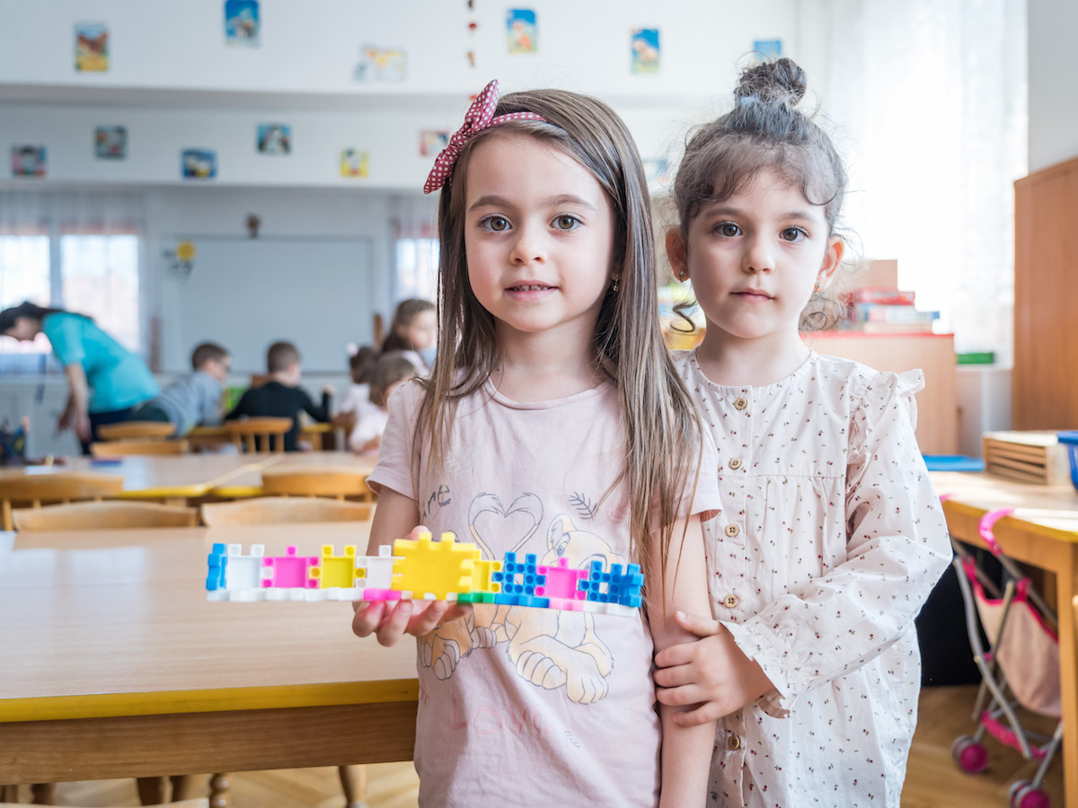 Two kindergarteners worked together to build something beautiful at their school in Brasov, Romania. 