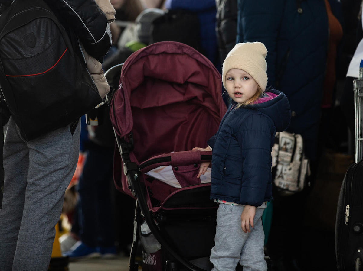 A child refugee from Ukraine stands in line at the border crossing between Ukraine and Moldova at Palanca on March 24, 2022. 