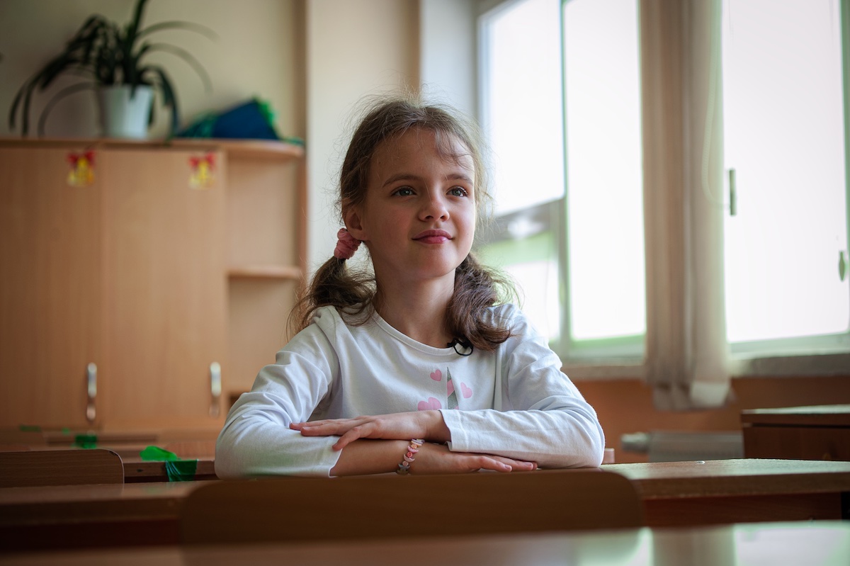 A 10-year-old girl from Ukraine sits in her new classroom at a school in Moldova that is welcoming refugee children with UNICEF's help.