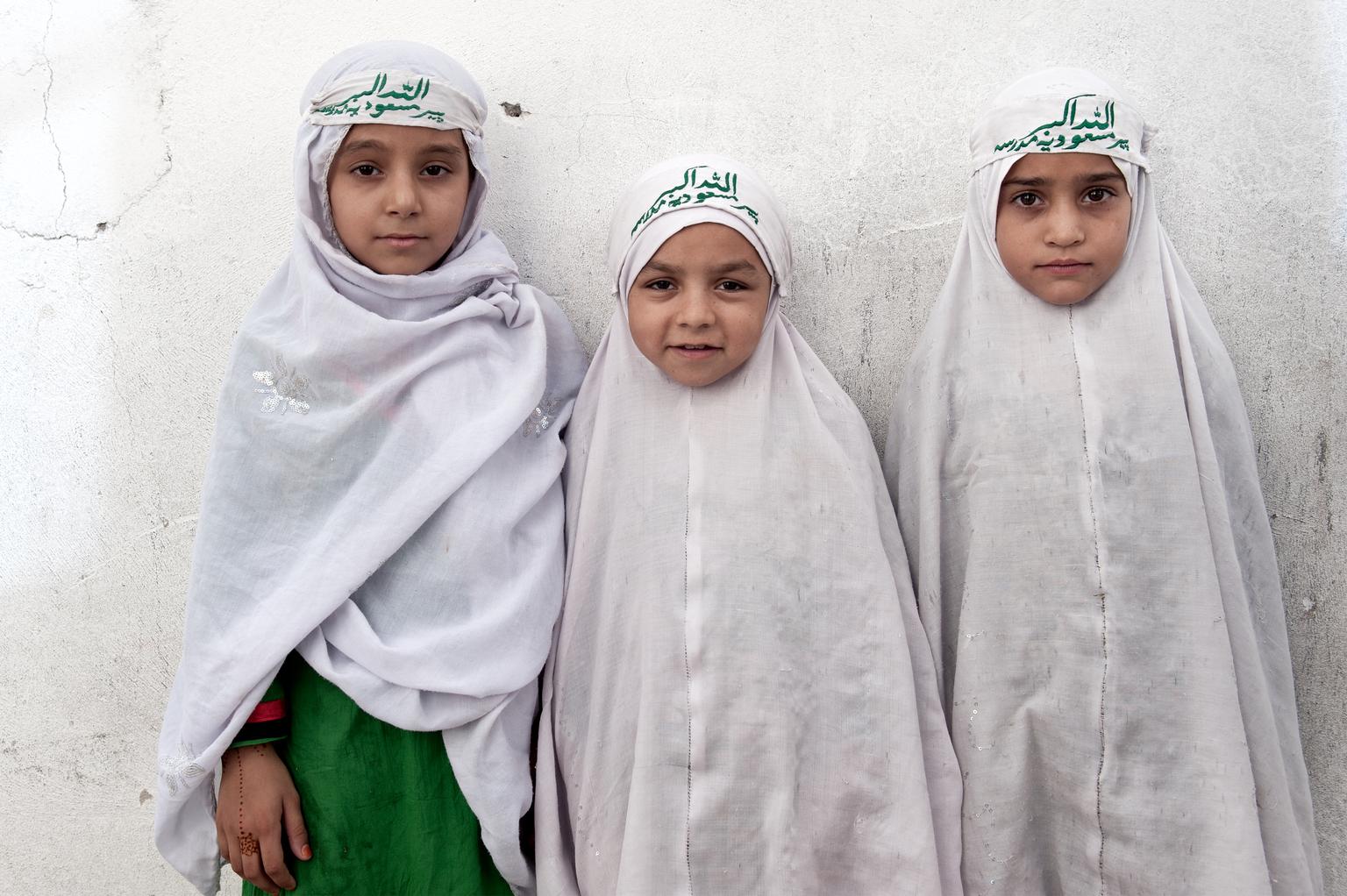 In July 2013 in Afghanistan, young girls stand by a wall at Peer Masoodia Madrasa in the southern city of Kandahar, capital of Kandahar Province. © UNICEF/NYHQ2013-0972/Dragaj