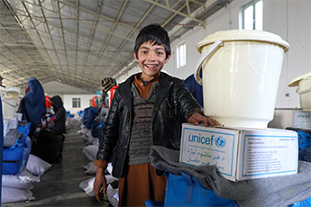 A health care worker gives a shot to a young boy