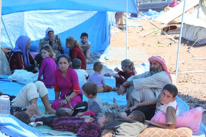 Yazidi children and families rest and shelter from the sun at Nawrouz refugee camp. © UNICEF Syria/2014/Razan Rashidi