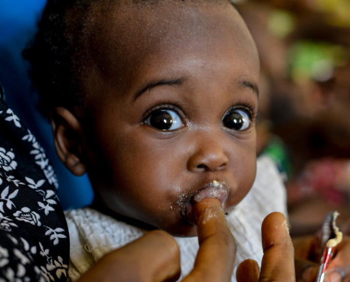 A baby eating some food.