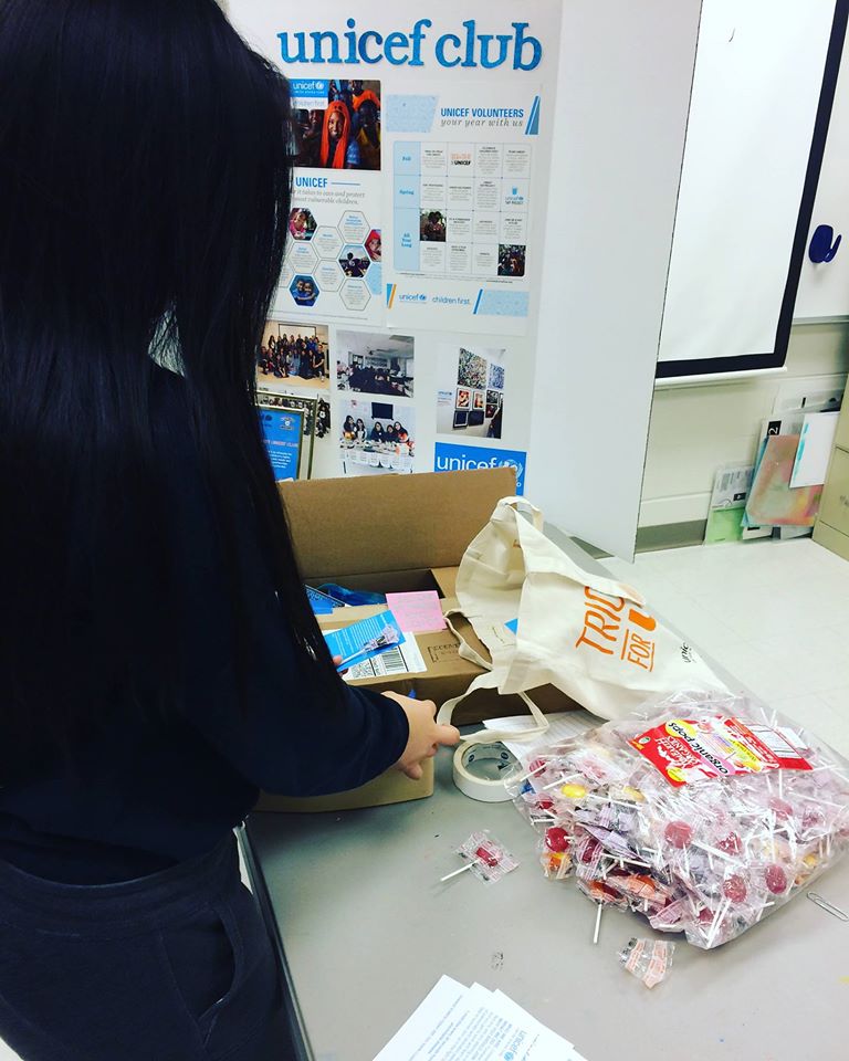 Niles West students unpack fair trade suckers to highlight fair trade goods