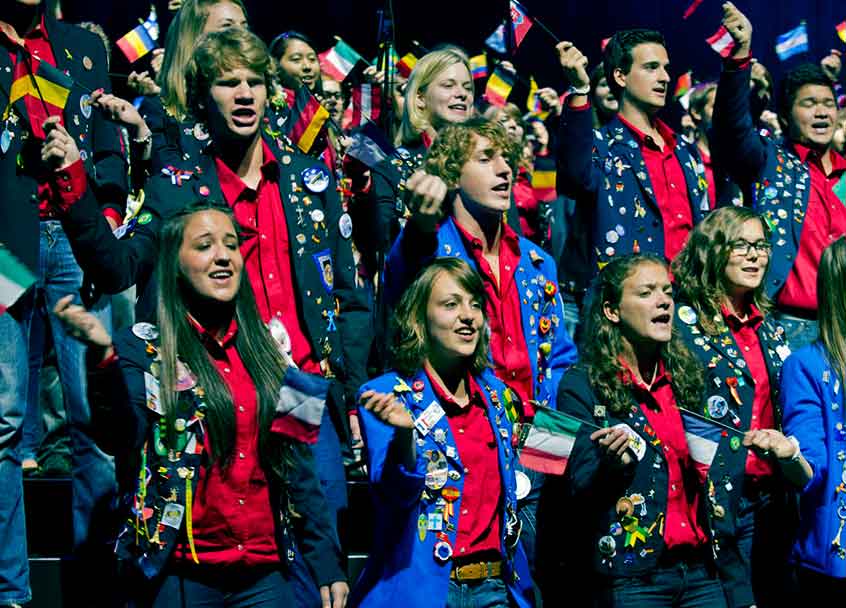 Rotary Youth Exchange Group Waving FLAGS
