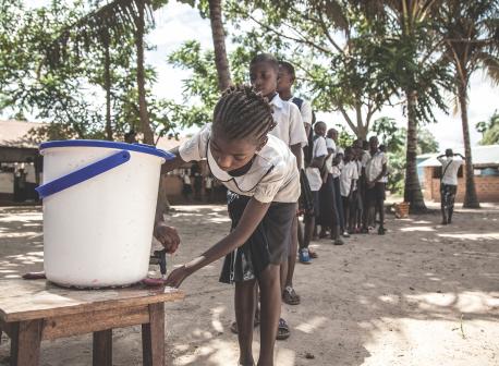 On May 22, 2018, children wash their hands to help contain the Ebola outbreak before entering a classroom in the north-western city of Mbandaka, in the Democratic Republic of the Congo. UNICEF has installed hand-washing points in 50 targeted schools in affected areas in the port city.