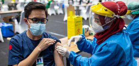 Man receiving a COVID-19 vaccination shot