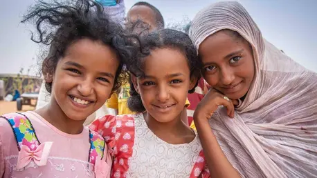 Young Malian refugees stand outside a food distribution point at the UNICEF-supported Mbera camp in Mauitania, near the Mali border.