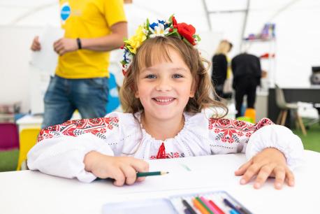 On Sept. 1, 2022, in Lviv, Ukraine, a girl draws at a Spilno center set up by UNICEF and partners to provide a welcoming place where children affected by the war can make friends, play, learn and connect with support services. 