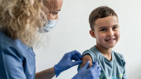 6-year-old Mykyta, a refugee from Ukraine, receives the vaccine for measles, mumps and rubella from Nurse Ewelina Tytula at a UNICEF-supported medical center in Kraków, Poland on Aug. 18, 2022.