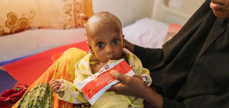 A malnourished 6-month-old is fed Ready-to-Use Therapeutic Food by his mother at UNICEF-supported Garowe General Hospital Stabilization Center in Puntland, Somalia, on Oct. 27, 2022.