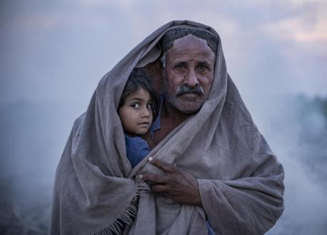 A father holds his 4-year-old daughter outside the family’s tent in flood stricken Dadu District, Sindh Province, Pakistan. 