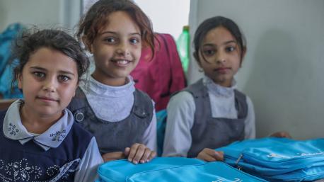 Students at Shuda Emirati School for Girls in Debaga, Iraq, unpack UNICEF-supplied learning materials.