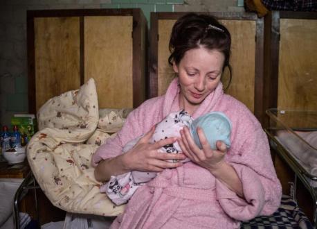 A mother holds her newborn baby, born in the basement of Kyiv Regional Perinatal Center amid shelling in March 2022. 