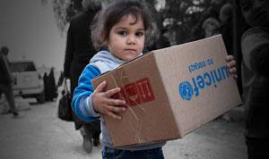 Little girl holding a box of UNICEF supplies