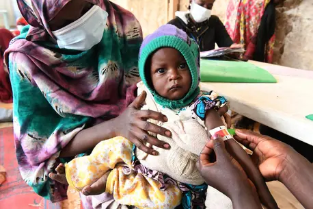 On Jan. 28, 2022, in Ndjamena, Chad, a child's upper arm circumference is measured by a health worker to screen for malnutrition at a UNICEF-supported outpatient nutrition unit.