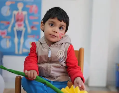 A child plays at a UNICEF-supported Child-Friendly Space in Ušivak, Hadžići, Bosnia and Herzegovina.