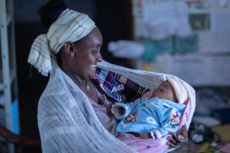 Kokobe Ashebir, 20, holds her 2-month-old baby during a routine checkup at a UNICEF-supported health clinic in Sire, Oromia region, Ethiopia.