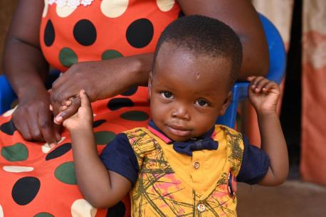 A young boy in Ouagadougou, Burkina Faso, whose mother has just received information about the importance of birth registration from a UNICEF U-Reporter.