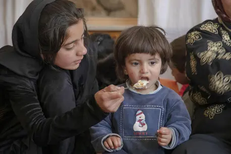 A mother feeds her child at the UNICEF-supported Anjerak nutrition center in Kabul.