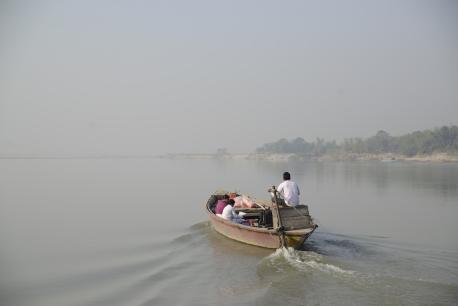 Health care workers travel two hours by boat to reach Fulkakata village in Assam state, northeastern India. 