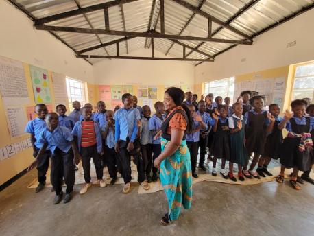 A teacher and her students at the Bimbe School in Chongwe district, Lusaka province, Zambia, where UNICEF and partners support an accelerated learning program to help students catch up.