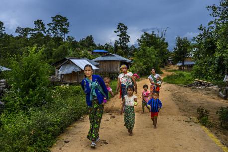 Ethnic Lahu women and their children head to the village church for a UNICEF-supported nutrition counseling session in Yan Mai village, Mong Khet Township, eastern Shan State, Myanmar.