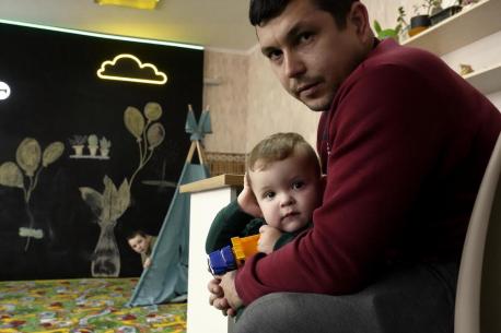 A father and son spend time at a UNICEF Spilno center in Kherson, Ukraine, in February 2023.